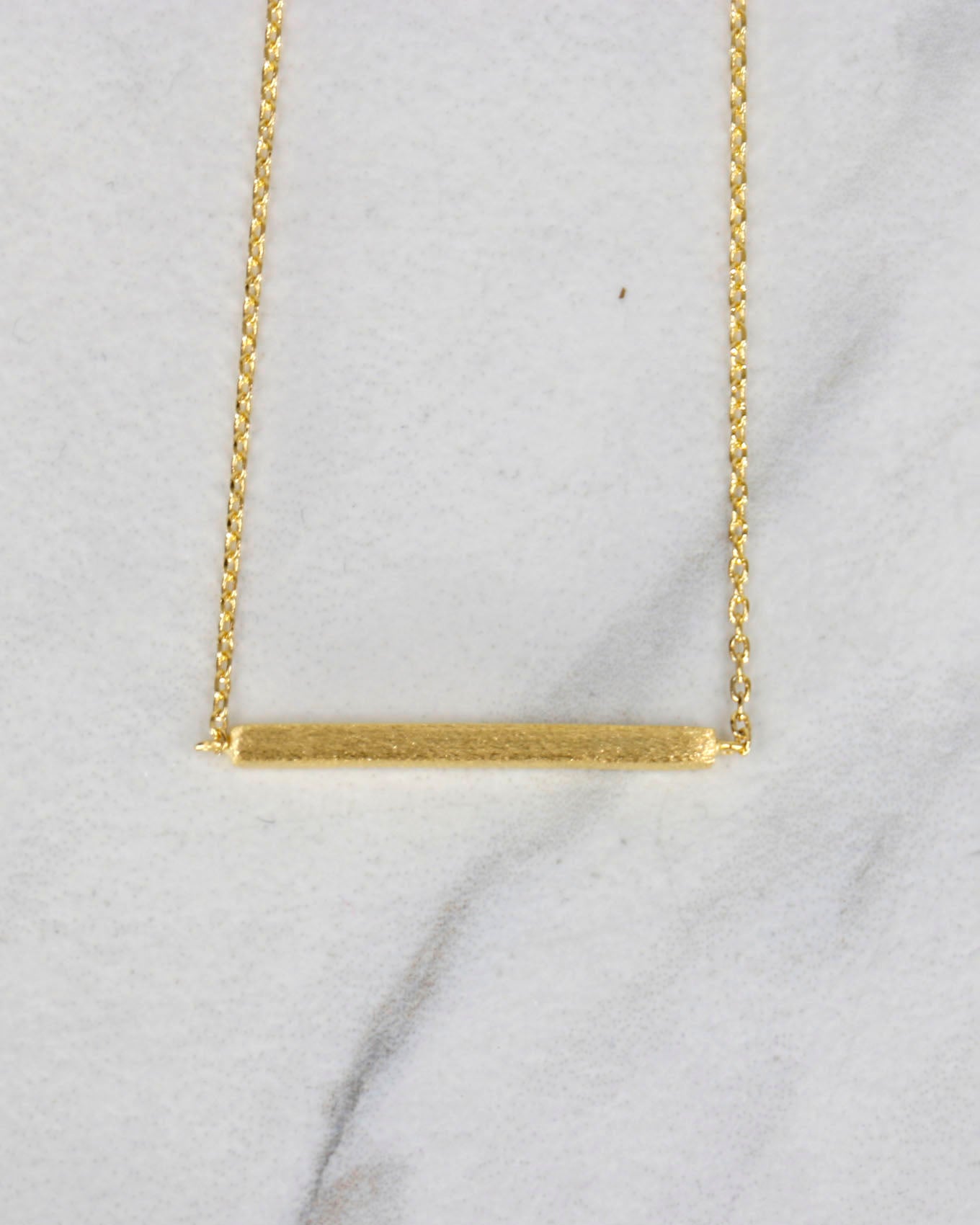 Close up view of Brushed Gold Bar Necklace