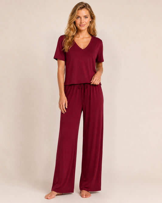 Dream Soft V-Neck Pajama Top in Cabernet Close up front view of a woman wearing a cabernet V-neck pajama top with matching wide-leg pants on a beige background