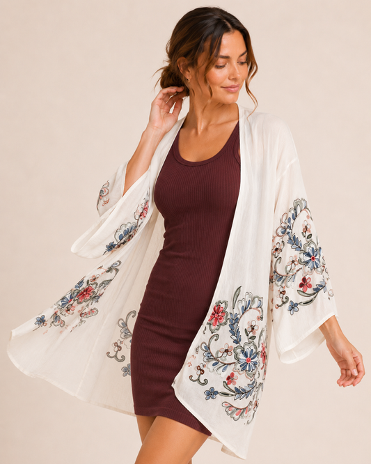 Floral Escape Cream Kimono Side view of a woman wearing a cream floral kimono over a burgundy ribbed tank dress on a beige background