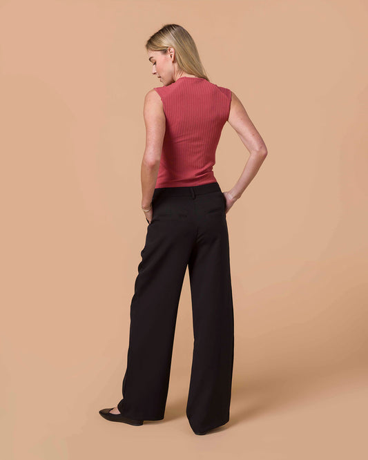 Pocketed Black Wide Leg Pants Woman wearing a pink sleeveless top and black pants on a beige background