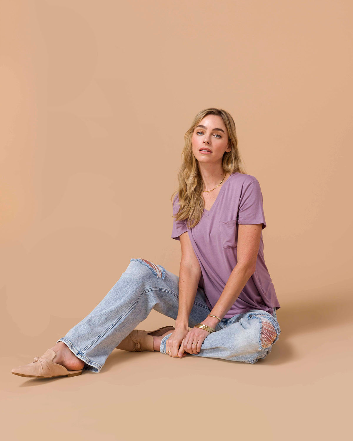 Blond model wearing a Perfect Fit Pocket Tee - Dusty Plum with denim sitting on floor.