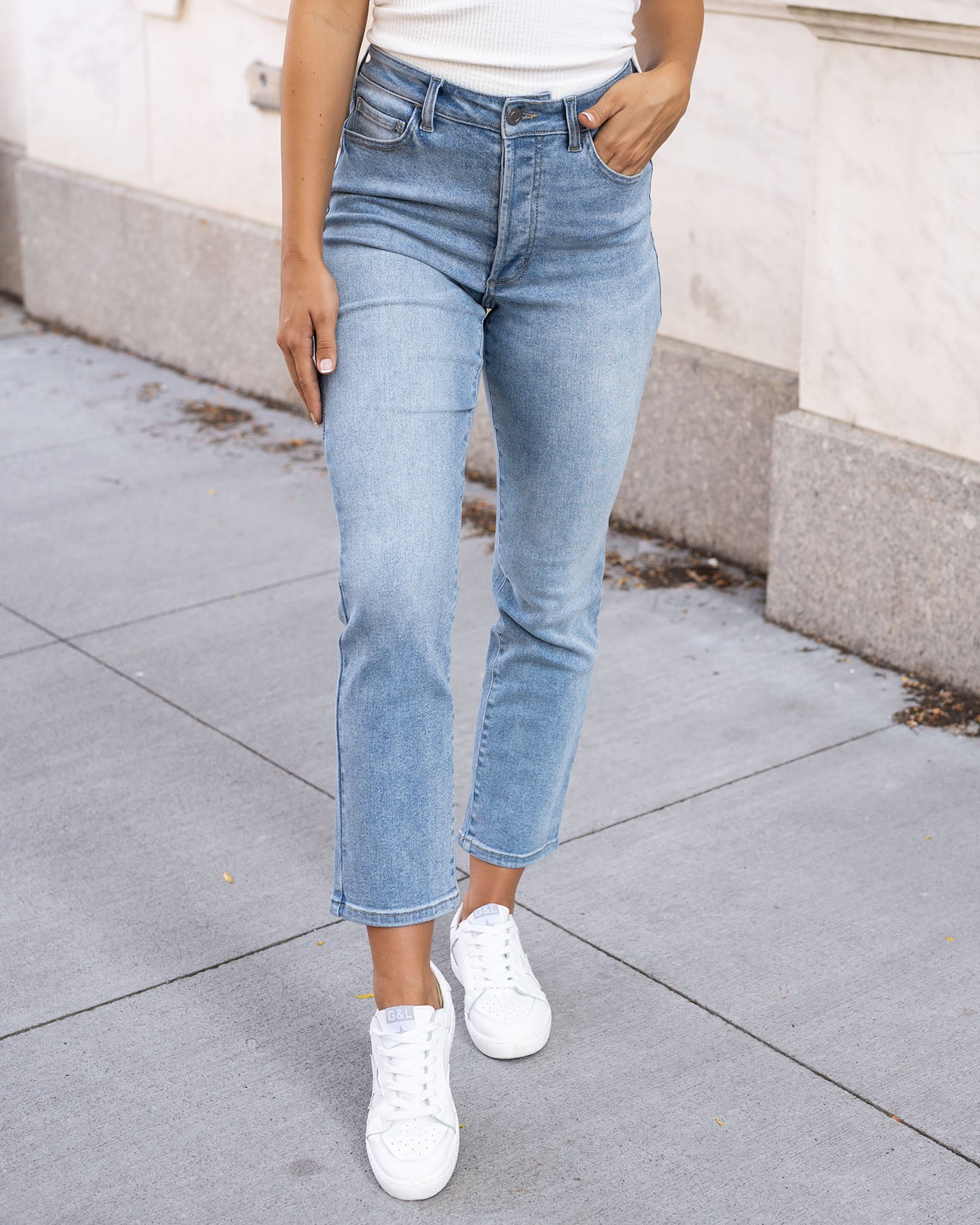 view of premium high waisted mom jeans in non distressed mid-wash