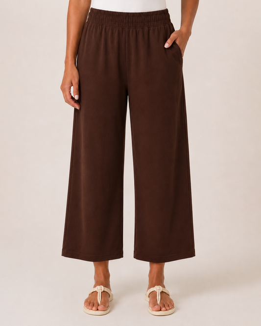 Weekend Ease Wide Leg Crop Pant in Brown Woman wearing brown wide-leg pants, a white tank top, and a beige button-front shirt on a beige background