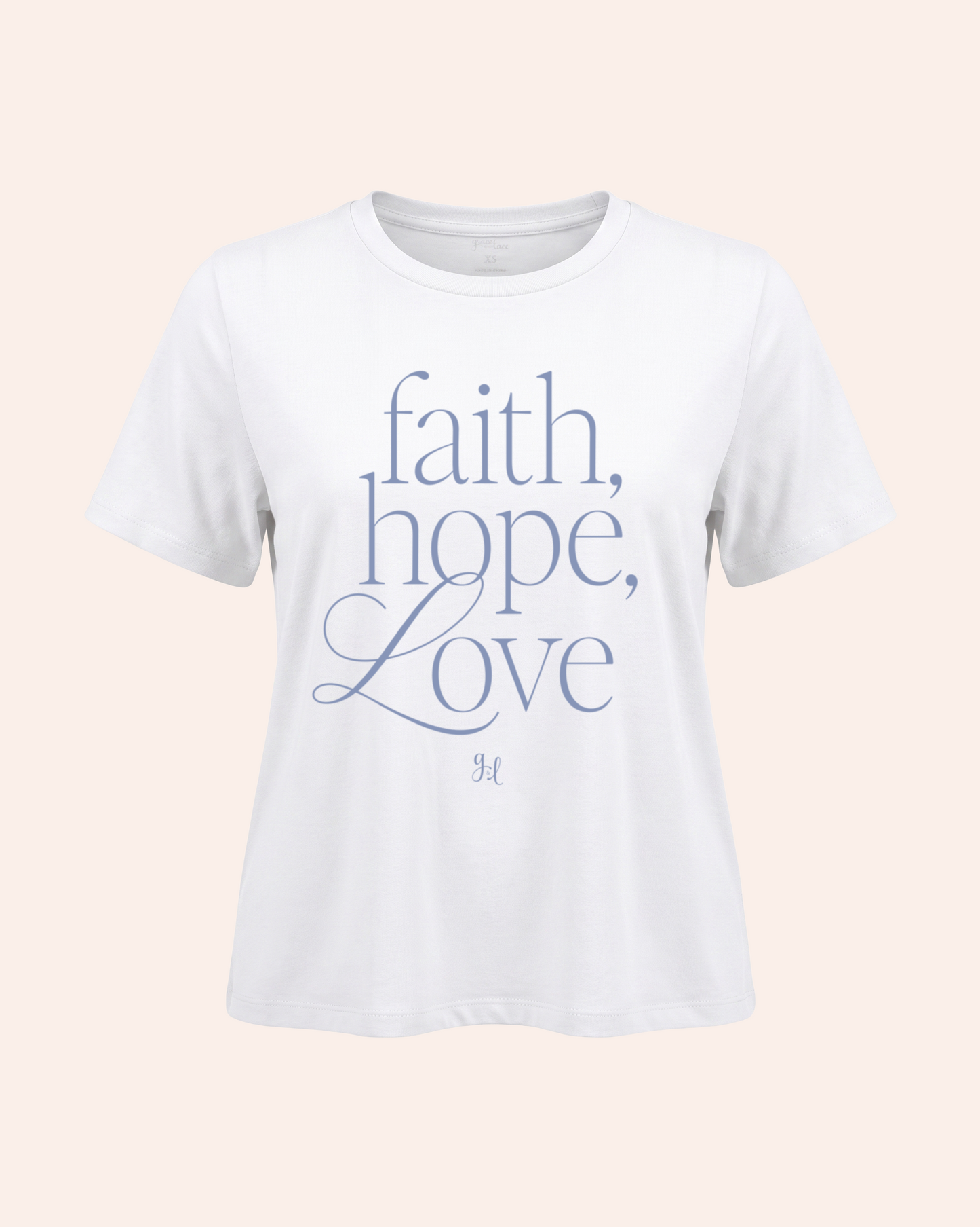 White t-shirt with 'faith, hope, love' text on a light pink background