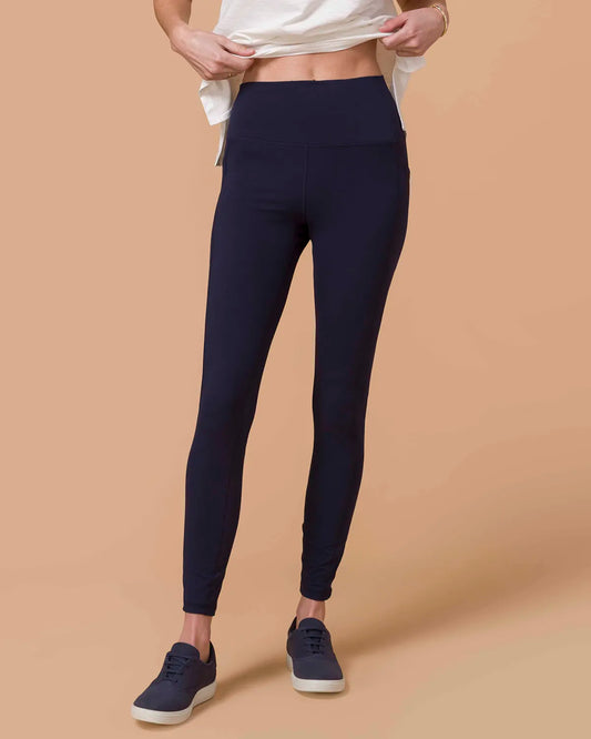 Best Squat Proof Leggings in Navy Blond woman wearing Navy Squat Proof Leggings with White top from waist view