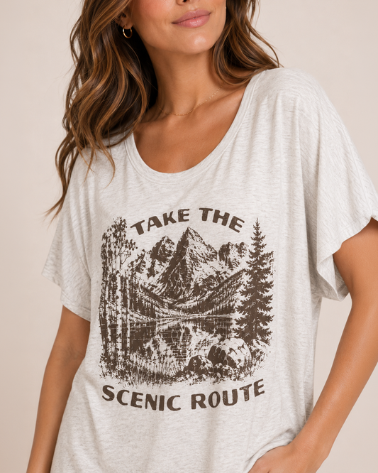 Take the Scenic Route Graphic Tee Front view of a woman wearing a navy graphic tee featuring a "Peace Comes in Waves" design and light wash denim shorts on a beige background