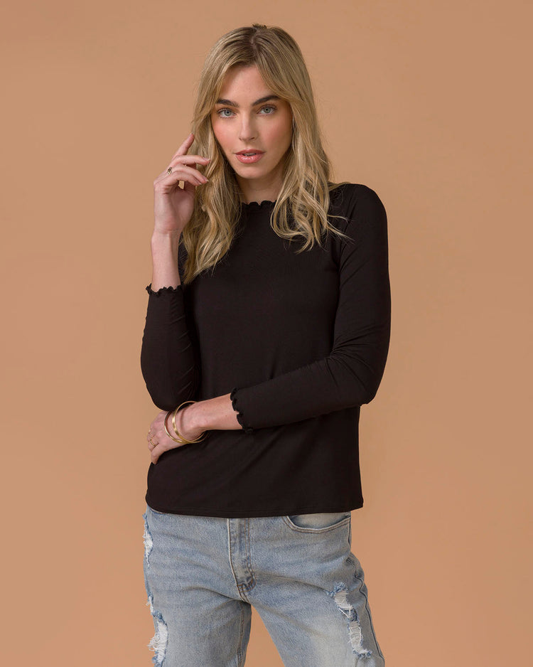 Woman wearing Black long sleeve tee and denim jeans