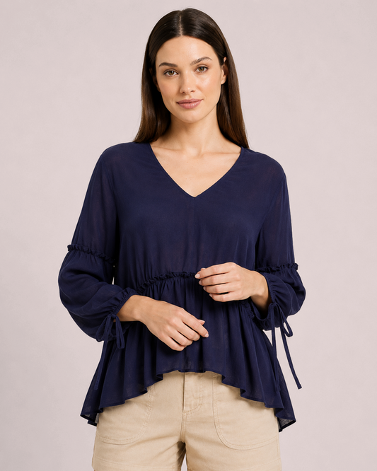 Soft Romance Peplum Blouse in Navy with Tan Linen Shorts on Model