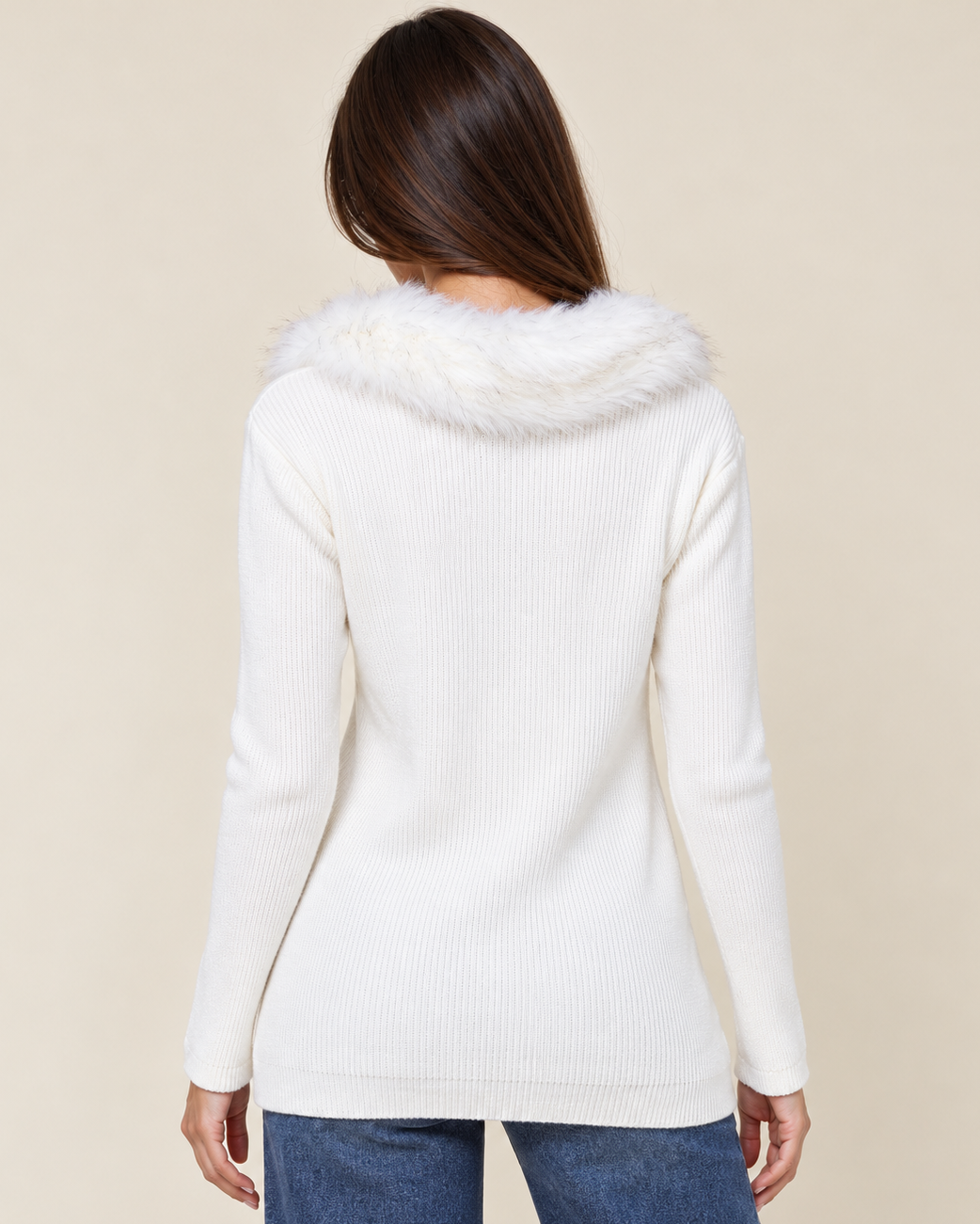 Back view of a woman wearing a white hooded open-front cardigan with long sleeves and blue jeans on a beige background.