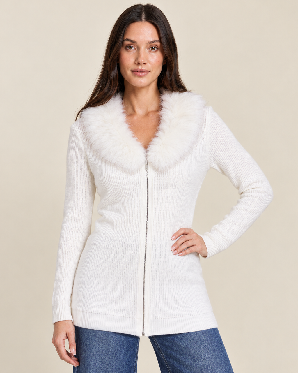 Front view of a woman wearing a white hooded open-front cardigan over a white top with blue jeans, highlighting the cardigan's long sleeves and open-front design on a beige background.