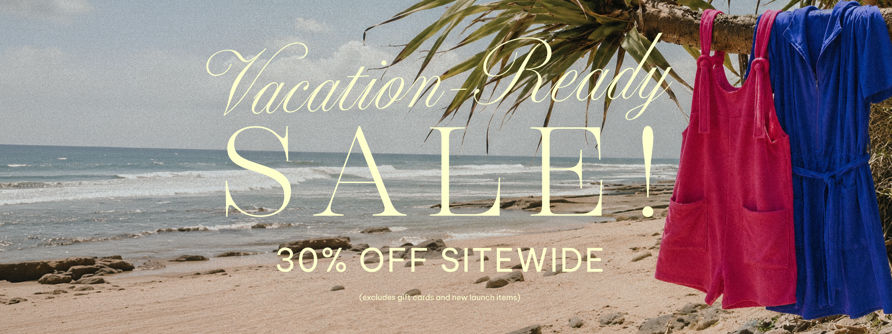 Beach scene with two dresses hanging on a palm branch, promotional text overlay for a sale.