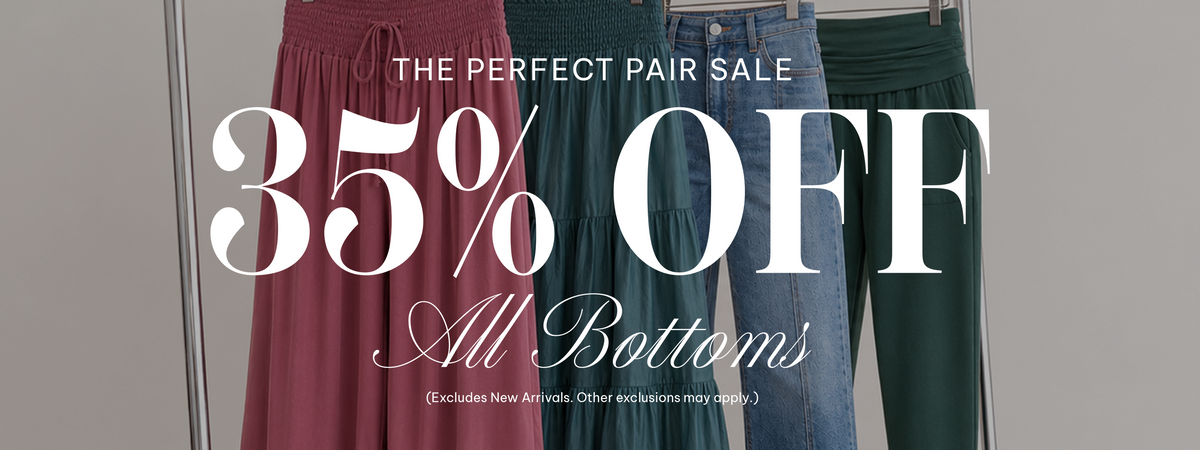 Promotional banner for a bottoms sale featuring three hanging pants: a dusty rose skirt on the left, a dark blue pair of jeans in the center, and a dark green pair of pants on the right. Large white text reads '35% OFF All Bottoms' with smaller text above saying 'THE PERFECT PAIR SALE'.