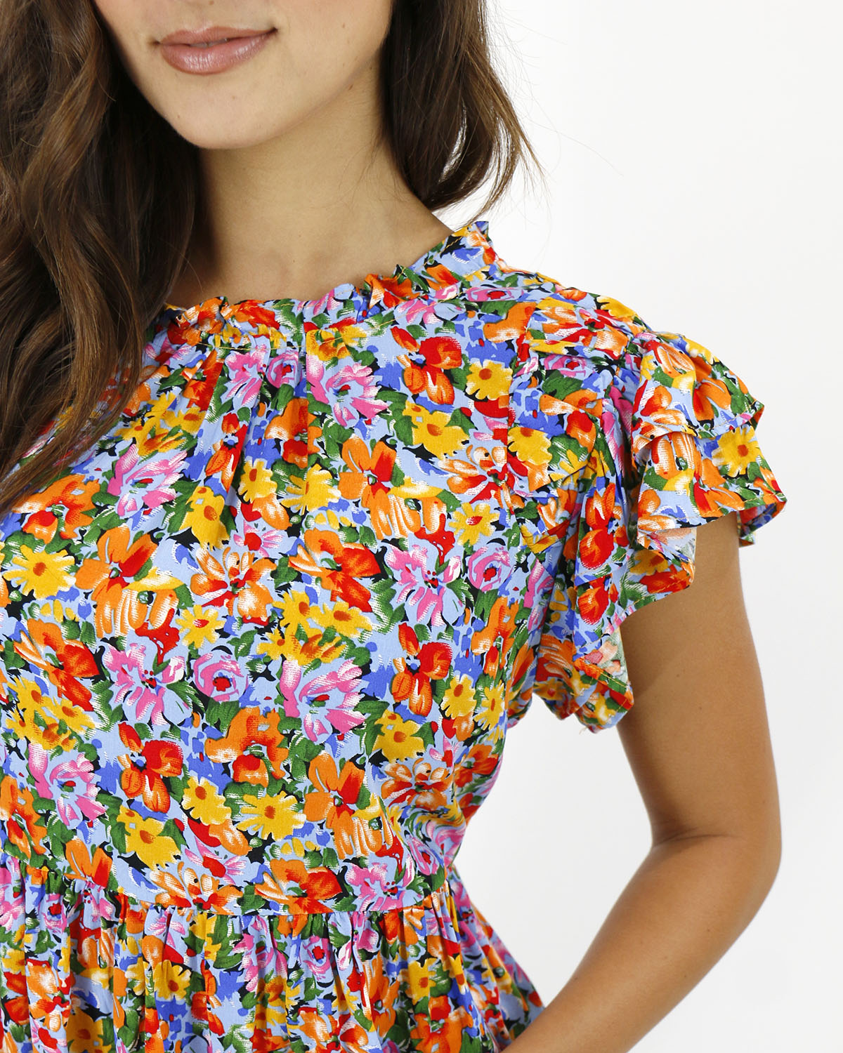 close up view stock shot of neckline and sleeve detail on ruffle sleeve women's blouse