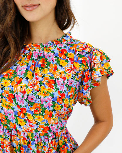 close up view stock shot of neckline and sleeve detail on ruffle sleeve women's blouse