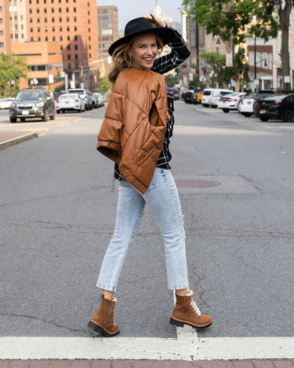 full body styled view of cognac faux leather puffer vest