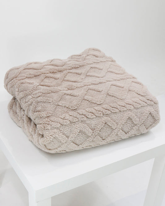 Styled view of Natural Cabled Sherpa Blanket