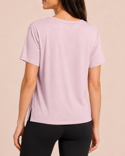 Back view of a woman wearing a Mauve Mist pajama top with matching wide-leg pants on a beige background