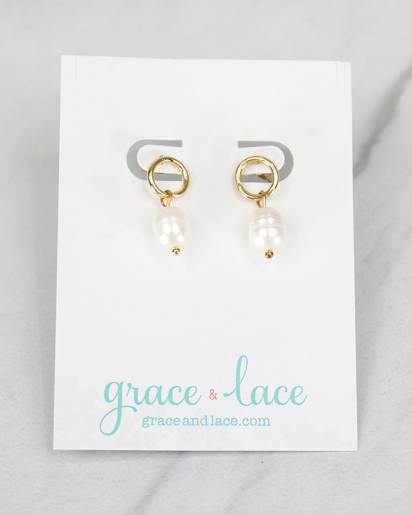 Close up view of Gold Drop Pearl Earrings