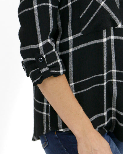 close up view of sleeve on favorite button up top in black plaid