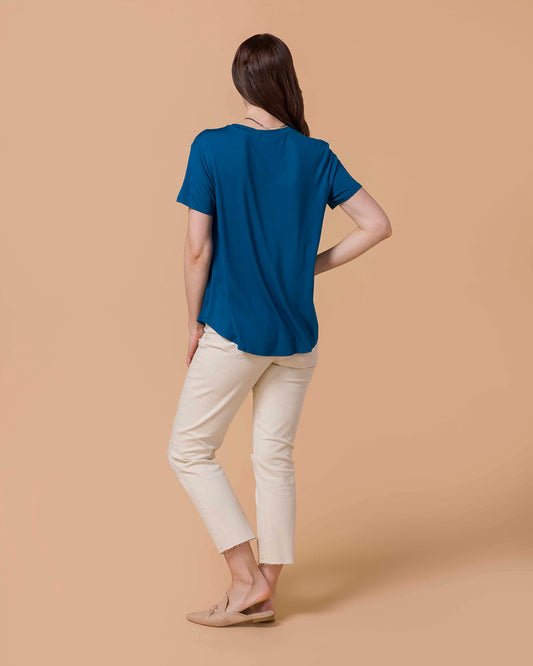 Woman wearing a Perfect Fit V-Neck Pocket Tee - Teal  and natural colored distressed denim