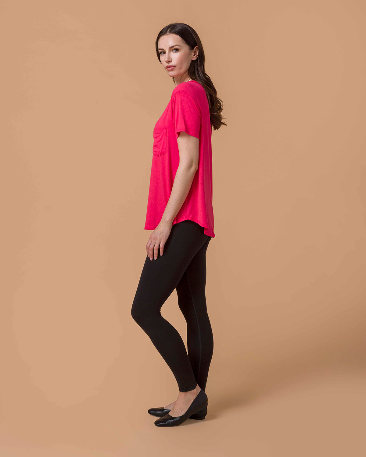 Woman wearing a Perfect Fit Pocket Tee - Canyon Red and black leggings side view