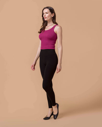 Brunette Model wearing Signature High-Rise Black Leggings and berry brami turned slightly to the side