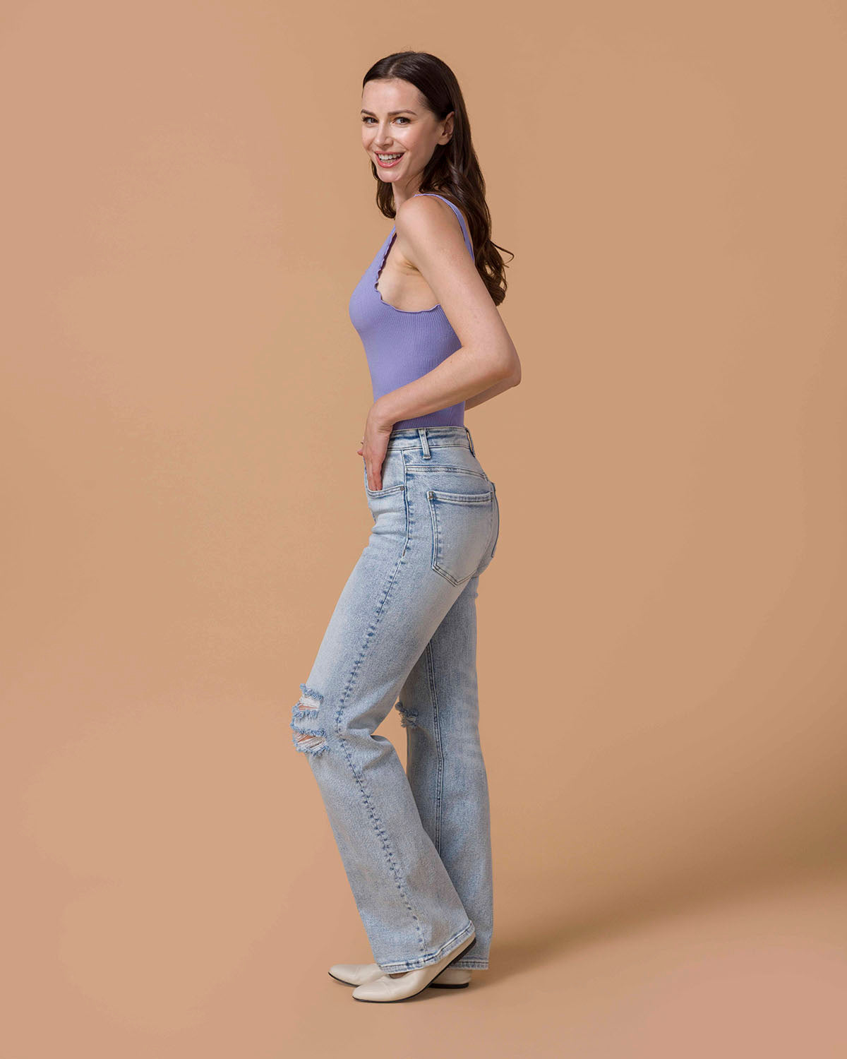 Woman wearing a purple top and Wide Leg Premium Denim in Distressed Light-Wash