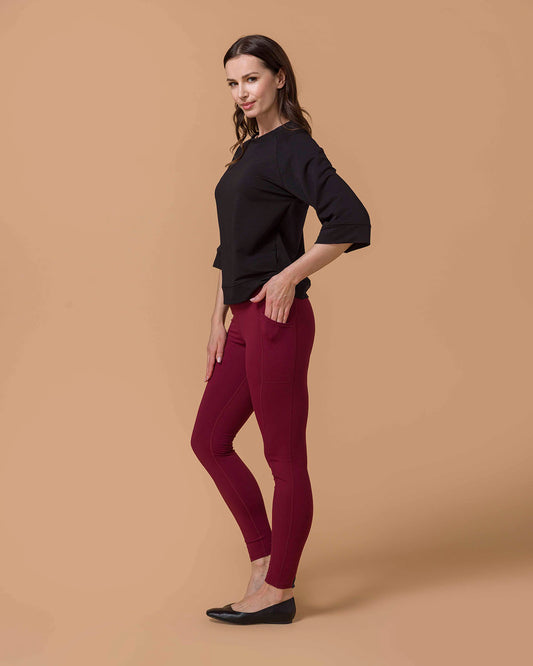 Woman wearing Best Squat Proof Leggings with Pocket in Cranberry and Black top