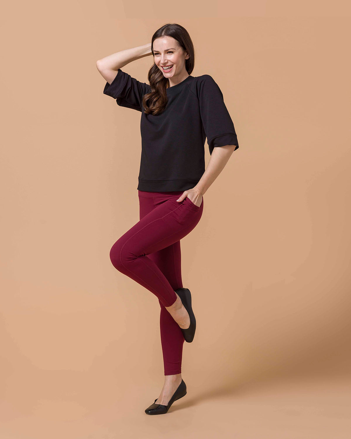 Woman wearing Best Squat Proof Leggings with Pocket in Cranberry and Black top