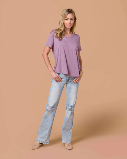 Blond model wearing a Perfect Fit Pocket Tee - Dusty Plum with denim sitting  and beige shoes.