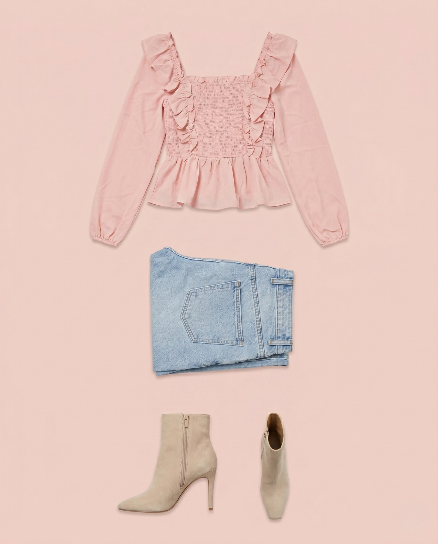 Pink ruffled peplum blouse styled with light blue jeans and ankle boots on a pink background