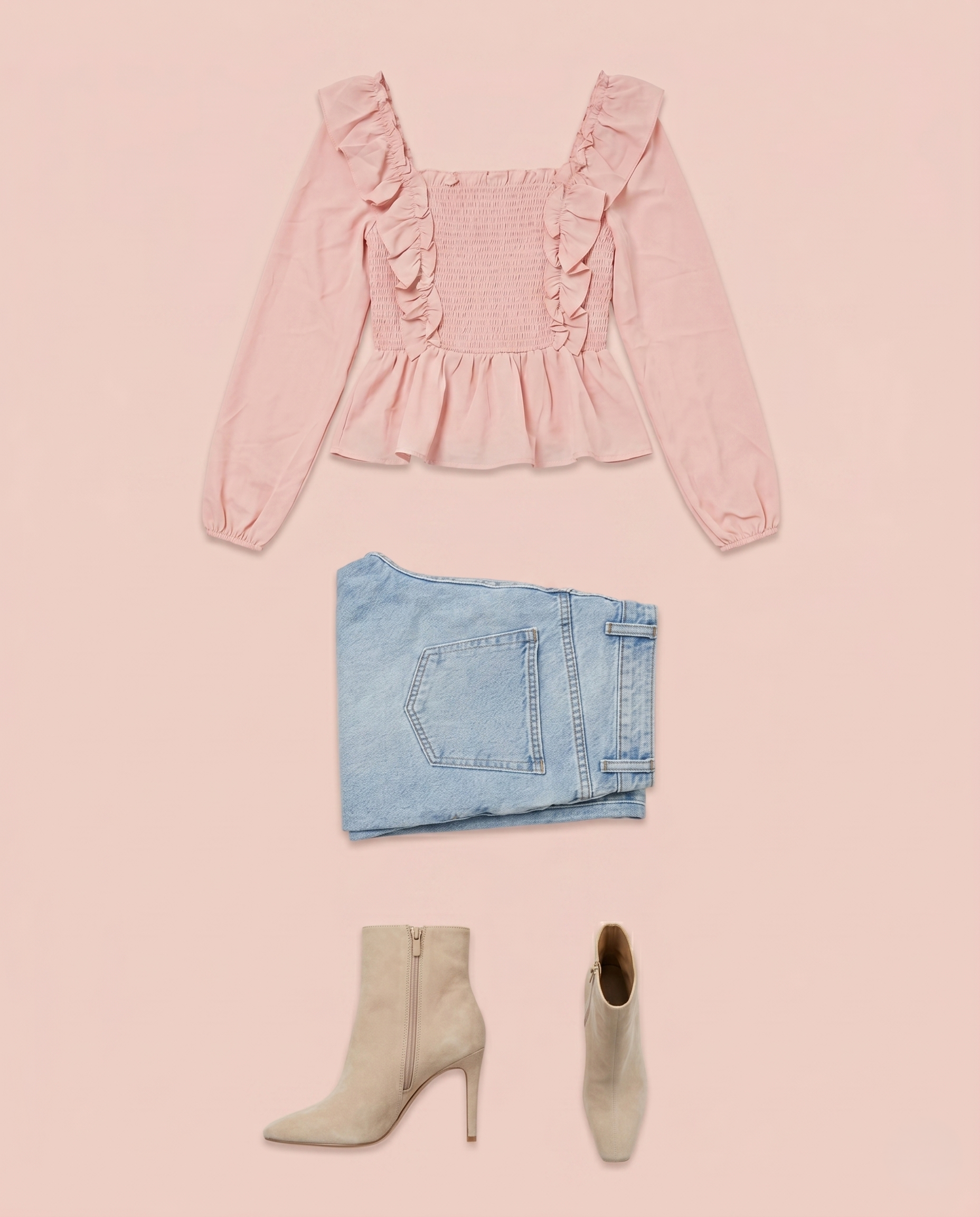 Pink ruffled peplum blouse styled with light blue jeans and ankle boots on a pink background