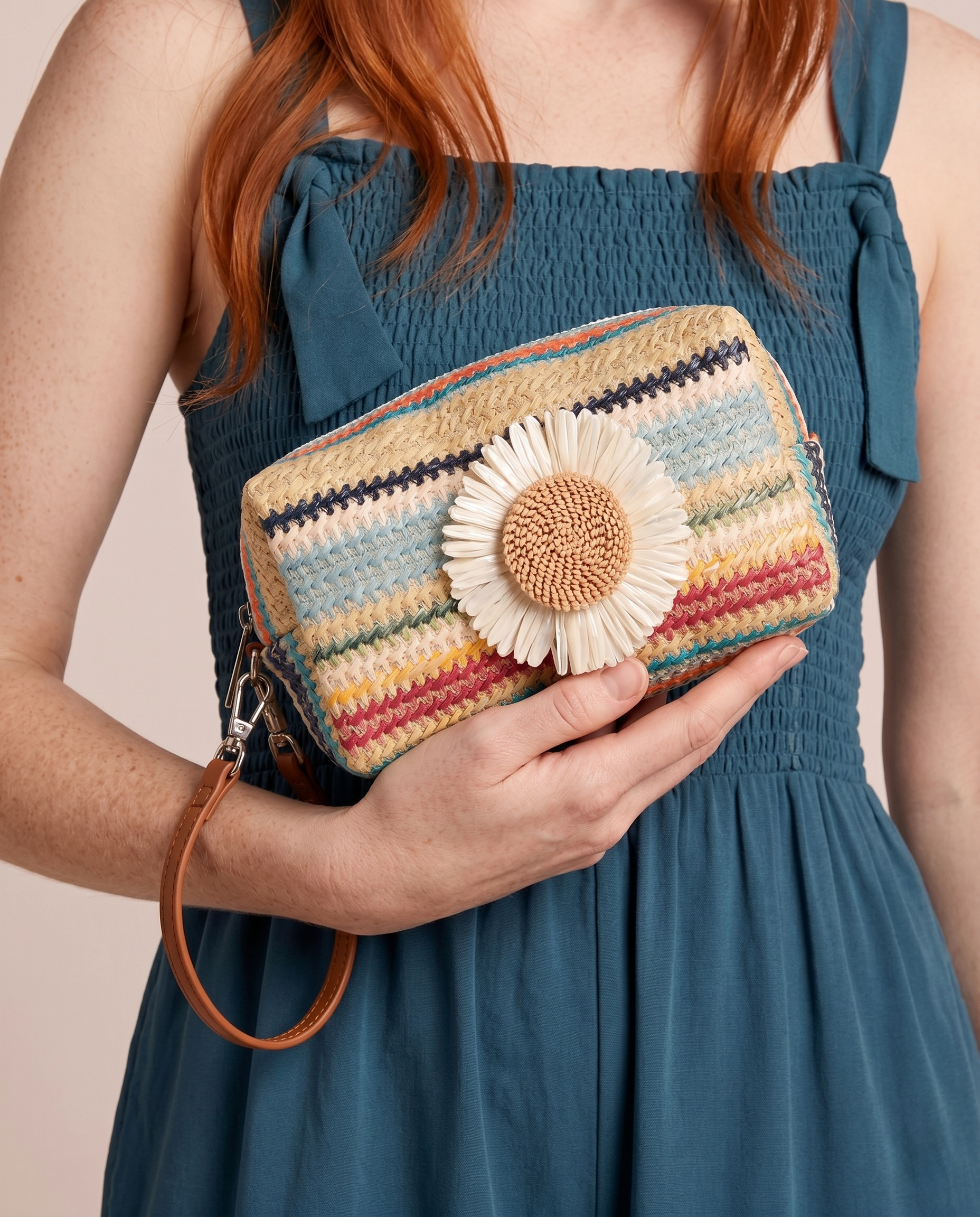 Model holding the Daisy Striped Summer Wristlet in Blue