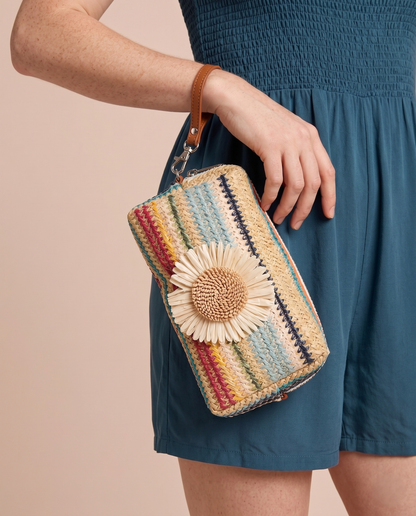 Daisy Striped Summer Wristlet in Blue on wrist of model wearing a blue romper.