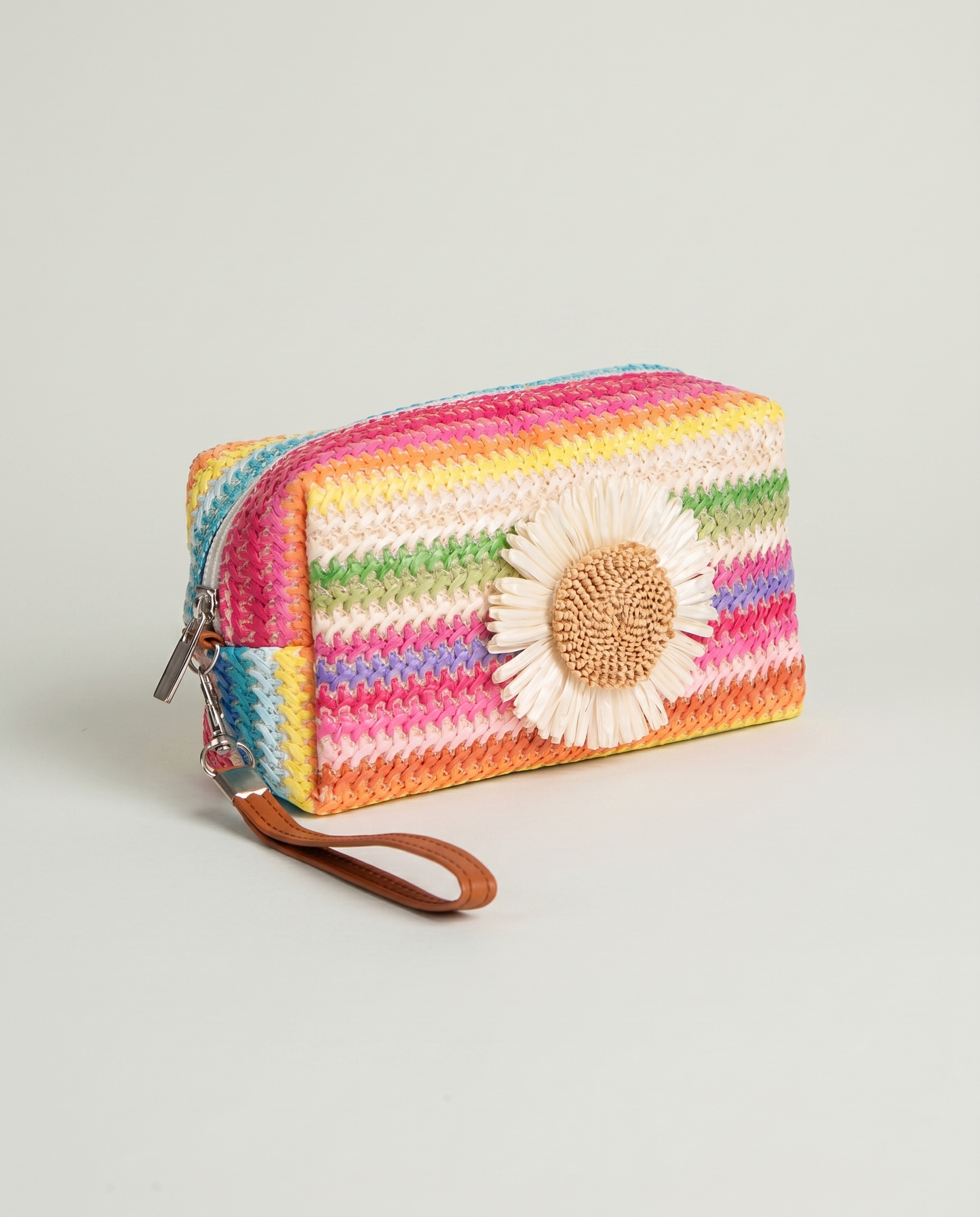 Angled view of Daisy Striped Summer Wristlet in Pink with colorful striped design