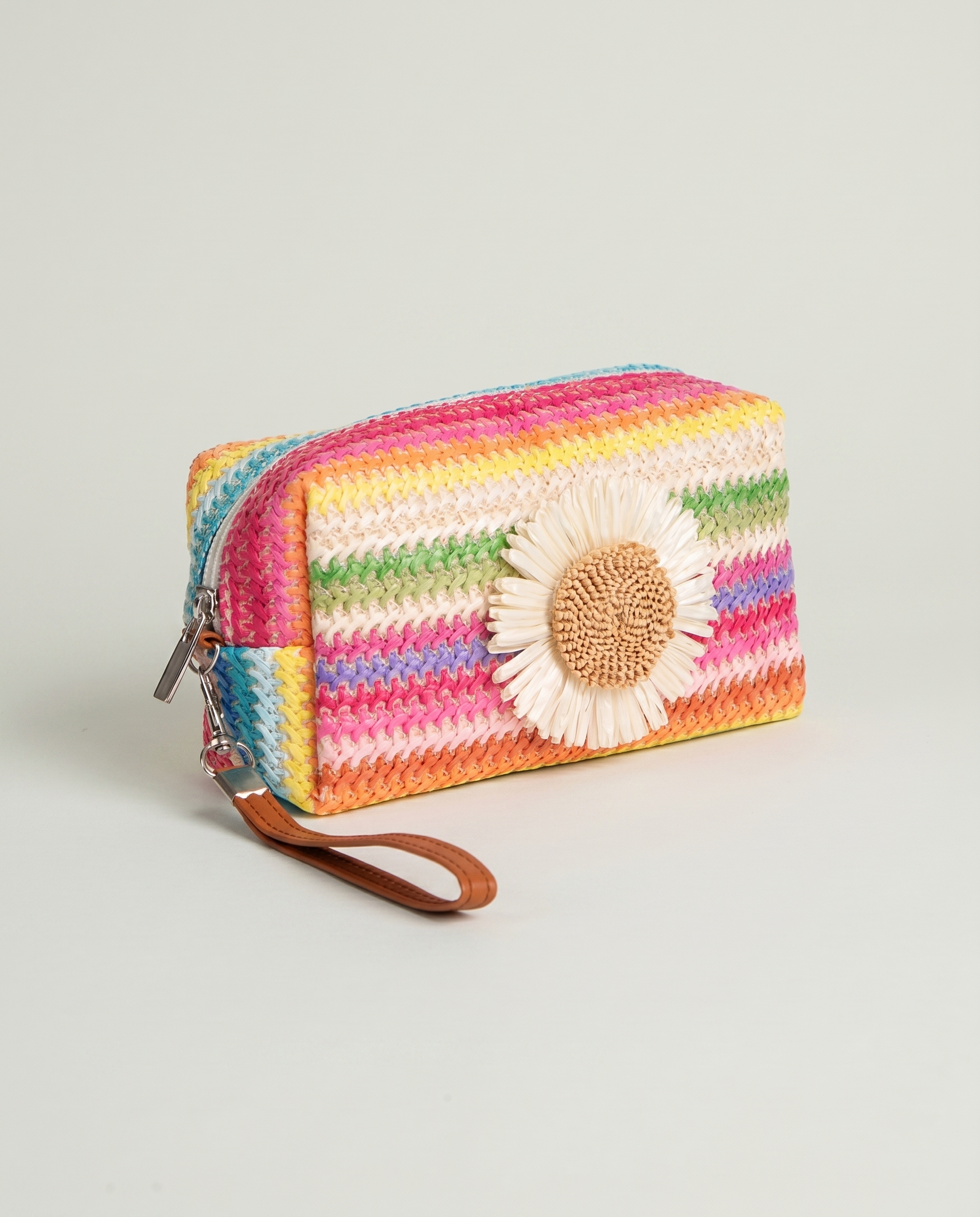 Angled view of Daisy Striped Summer Wristlet in Pink with colorful striped design