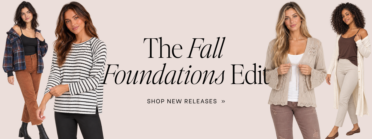 A promotional banner for 'The Fall Foundations Edit' featuring four female models wearing different casual autumn outfits against a solid pale pink background, with text reading 'The Fall Foundations Edit' and 'SHOP NEW RELEASES >>'.