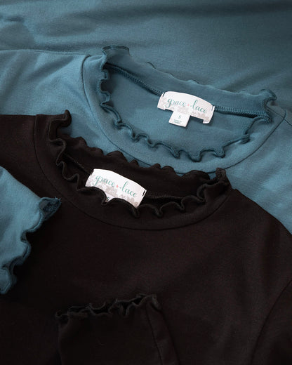 Black and teal shirts with ruffled details and visible Grace & Lace labels