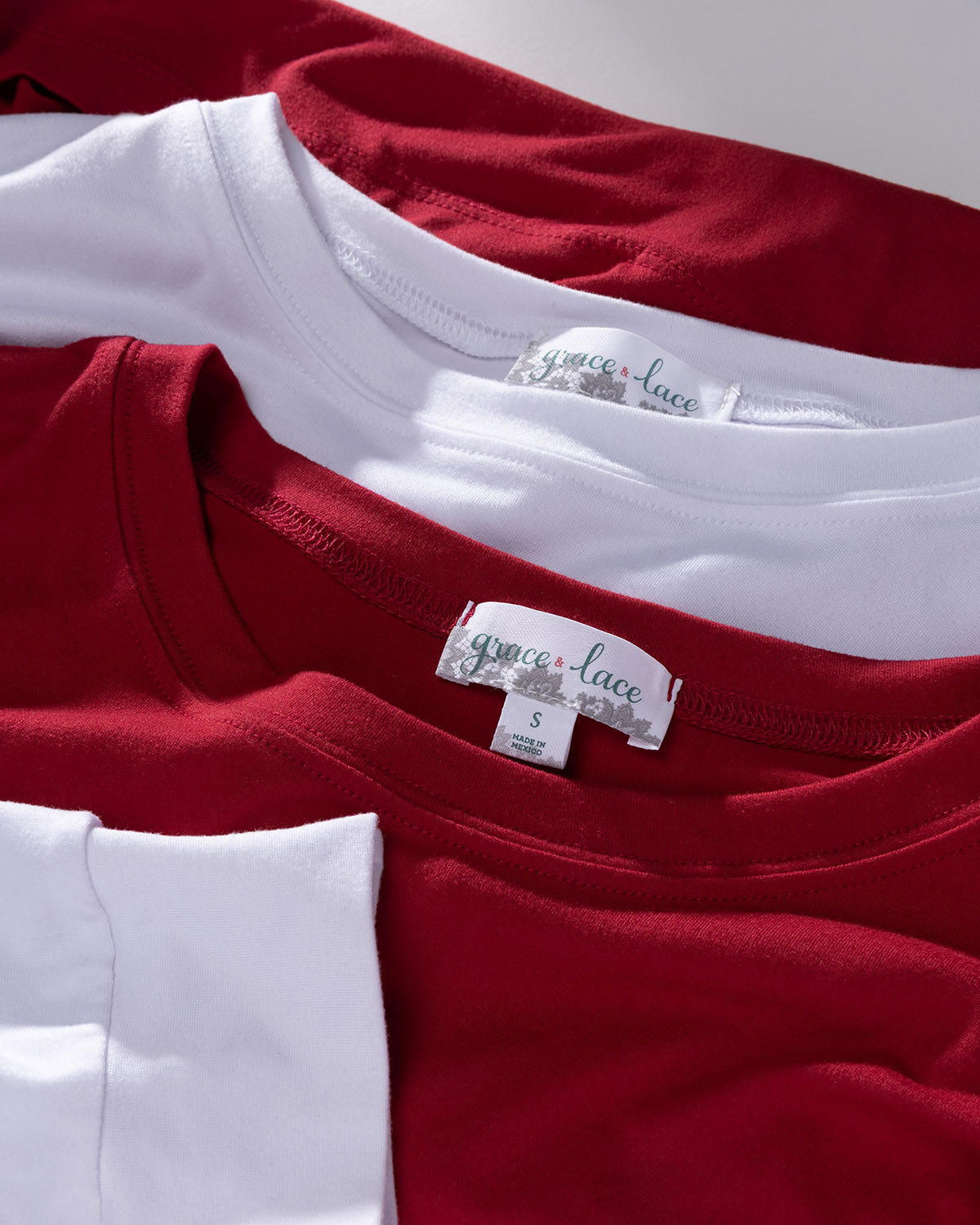 Close-up of red and white tops with Grace & Lace label on a white background