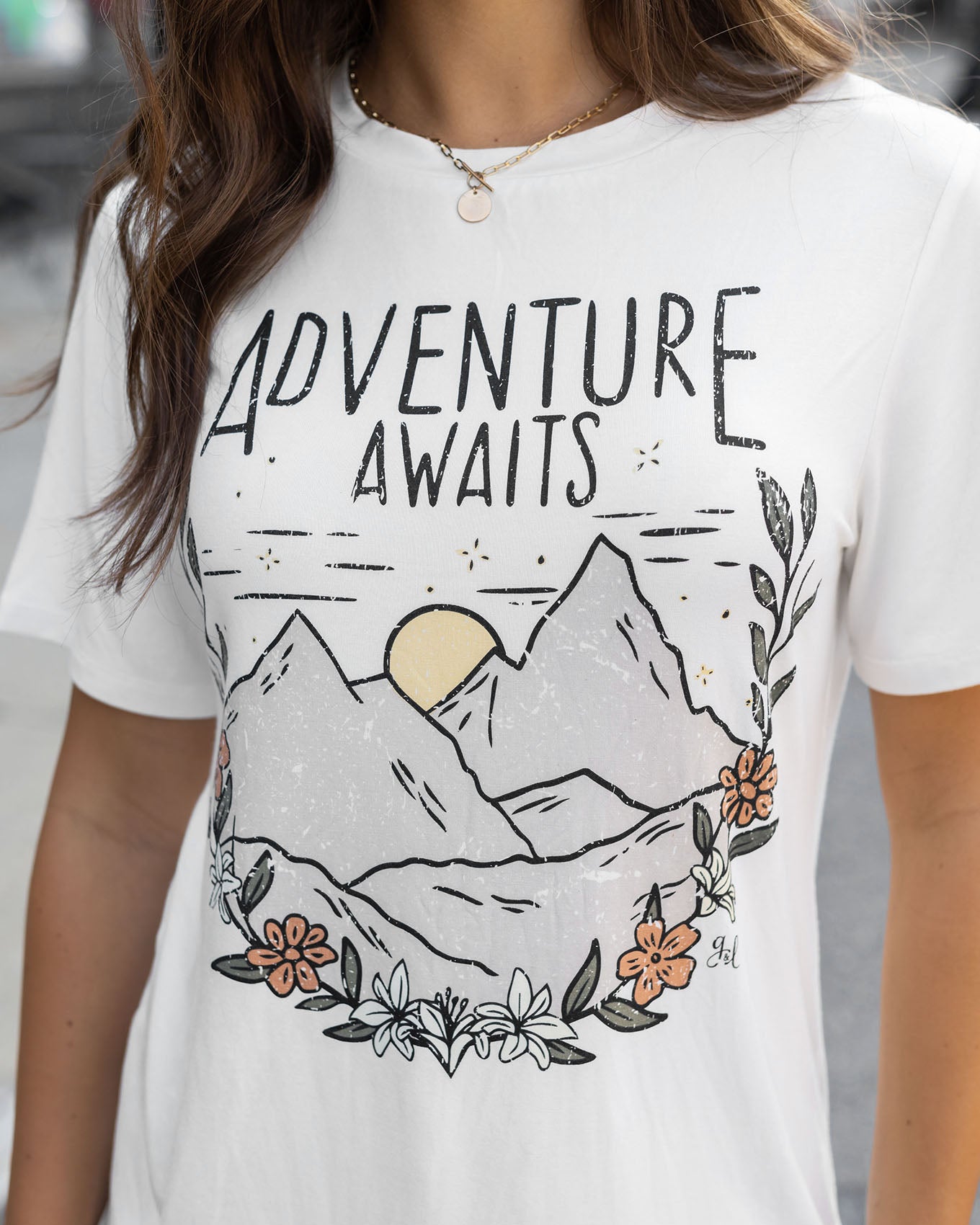 detail view of adventure awaits graphic tee