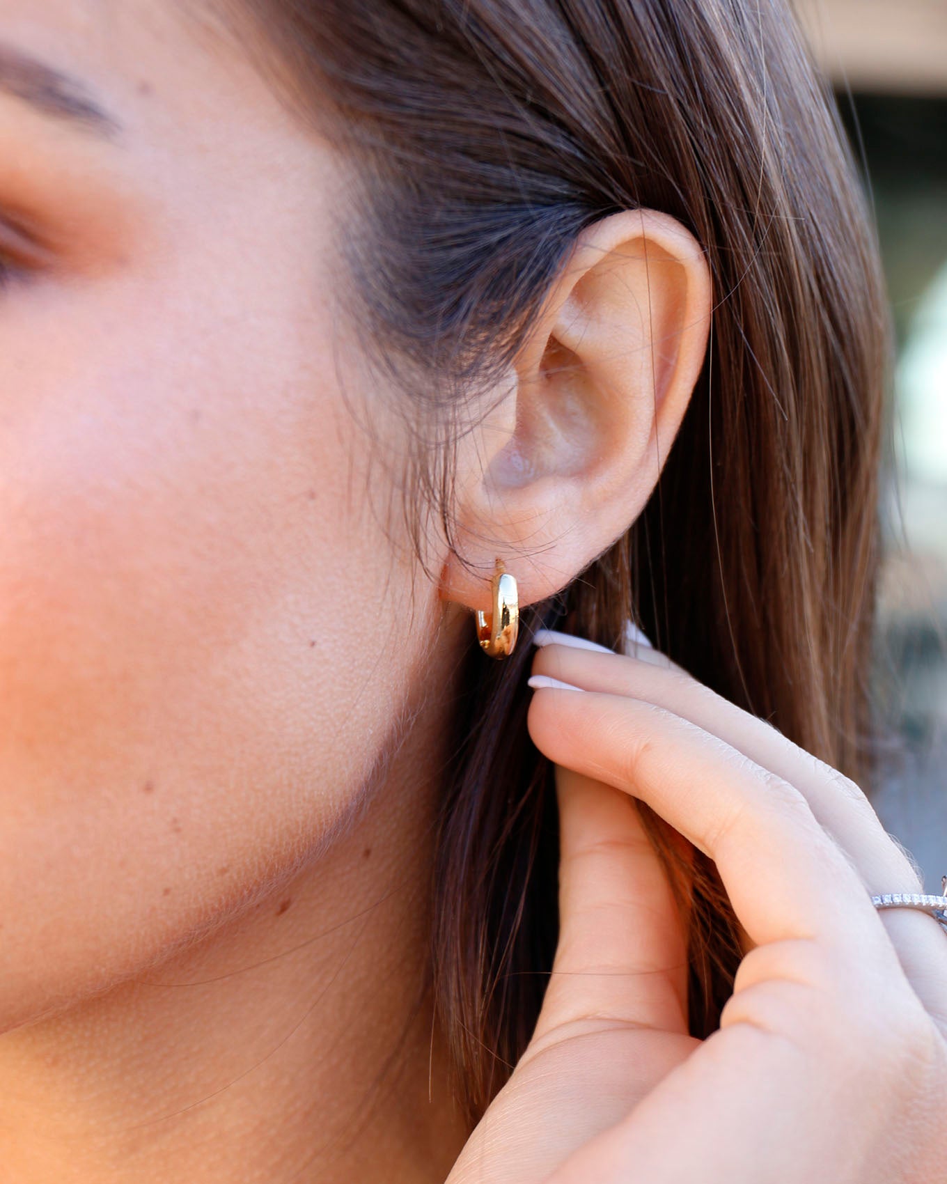 Styled view of Gold Huggie Earrings