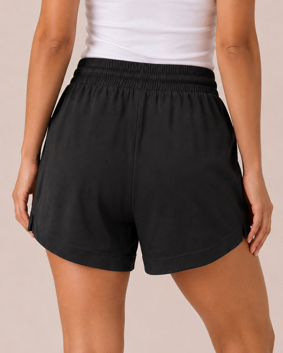 Back view of a woman wearing black comfort shorts on a beige background