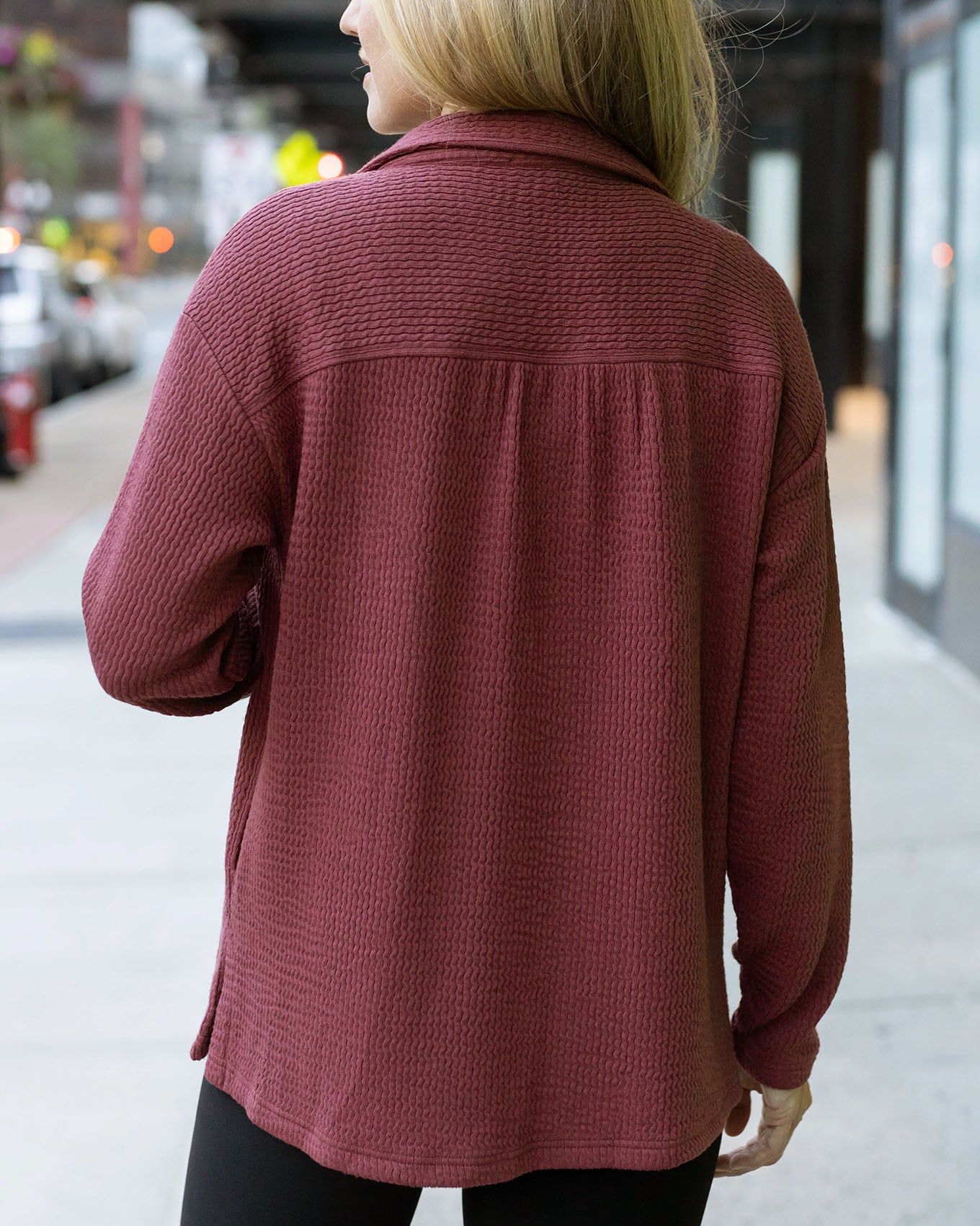 back view of red ribbed shacket
