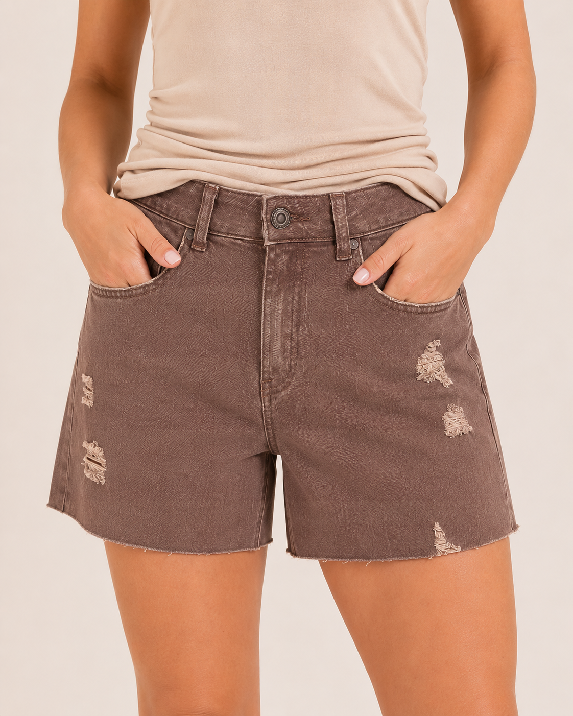 Close-up front view of wine distressed shorts on a beige background