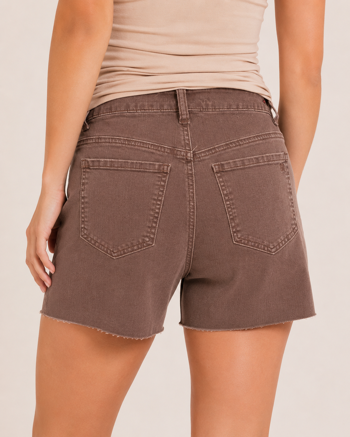 Back view of wine distressed shorts on a beige background
