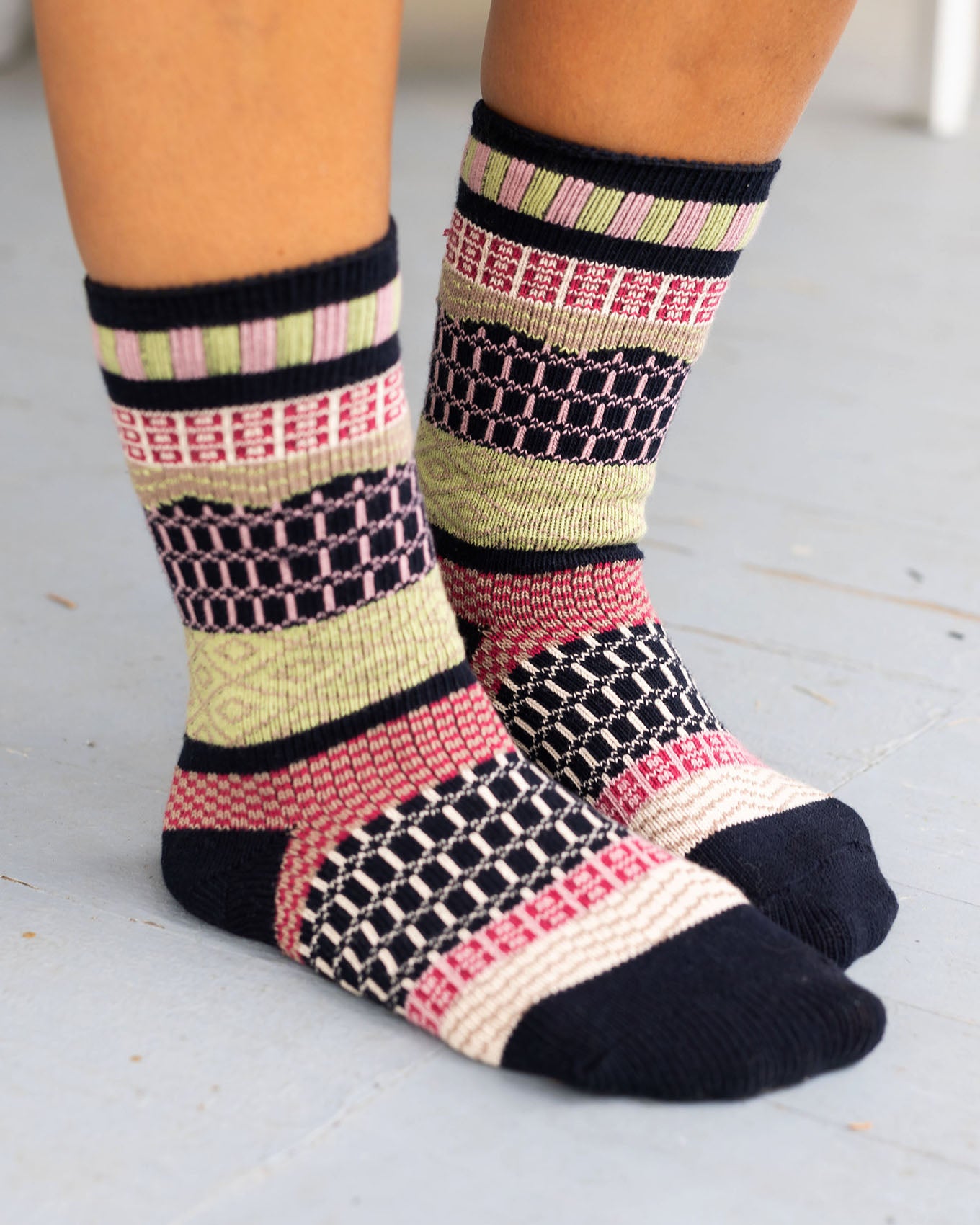 side view of navy/pink/lime intarsia socks
