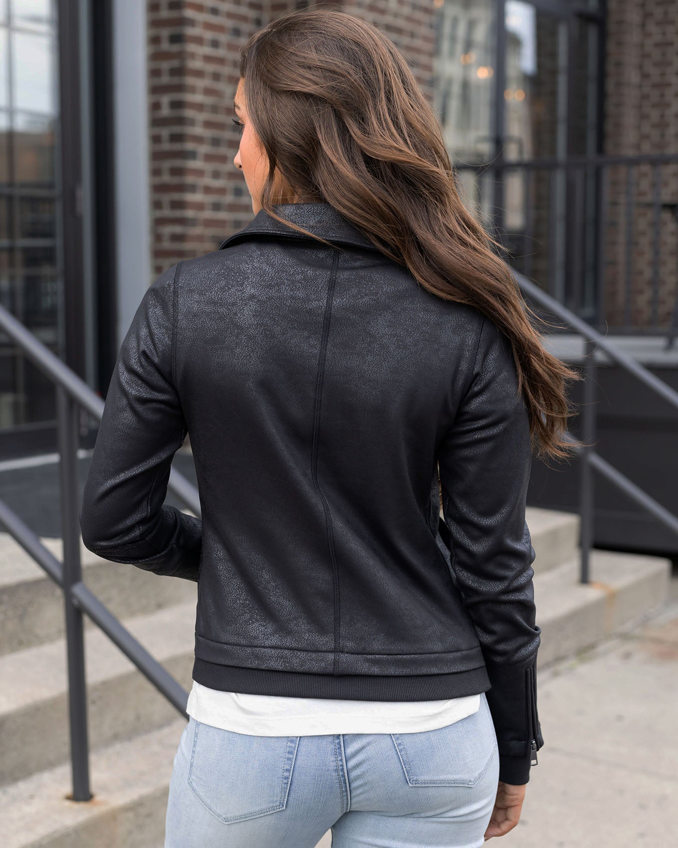 back view of black move-free leather like moto jacket