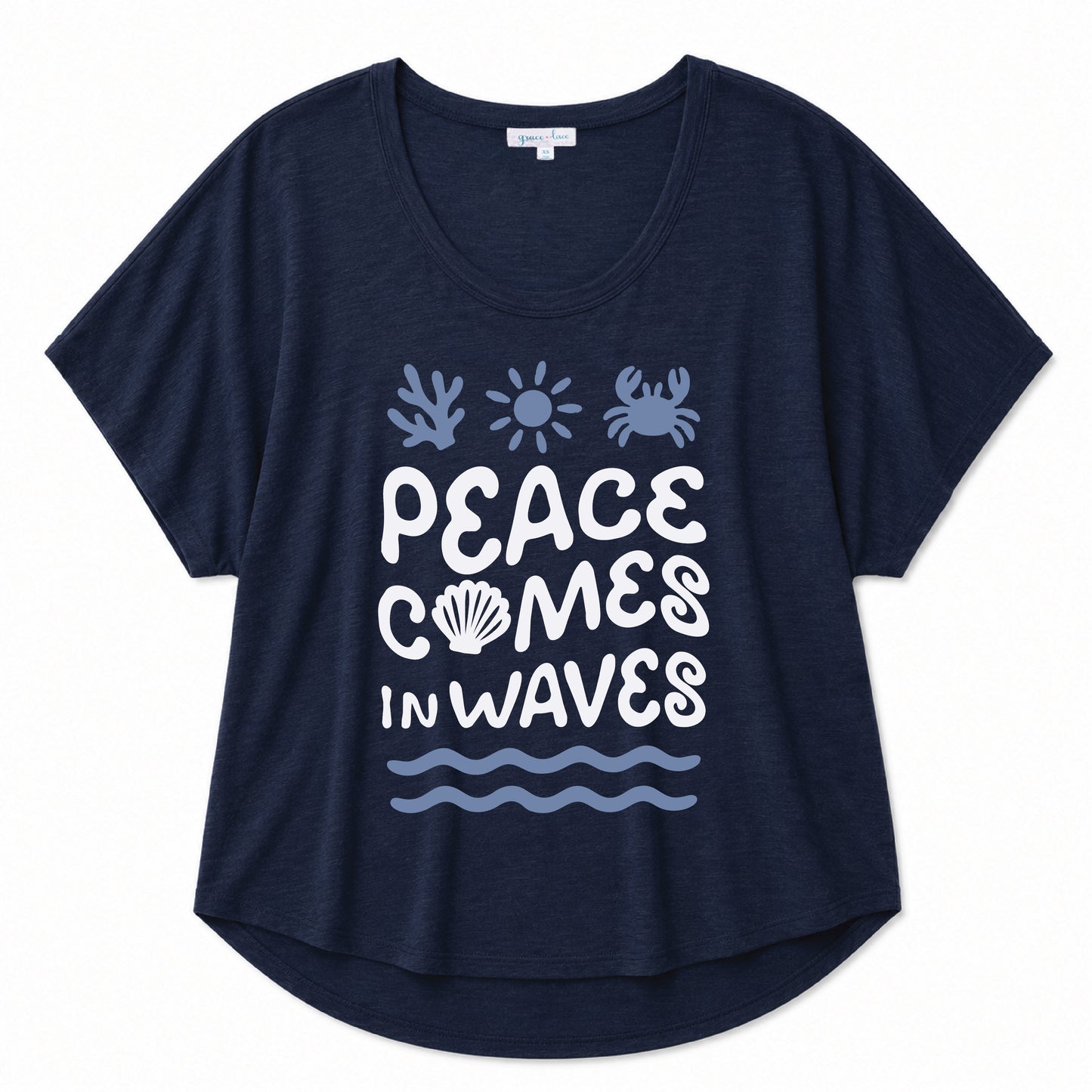 Navy graphic tee featuring a "Peace Comes in Waves" design on a beige background