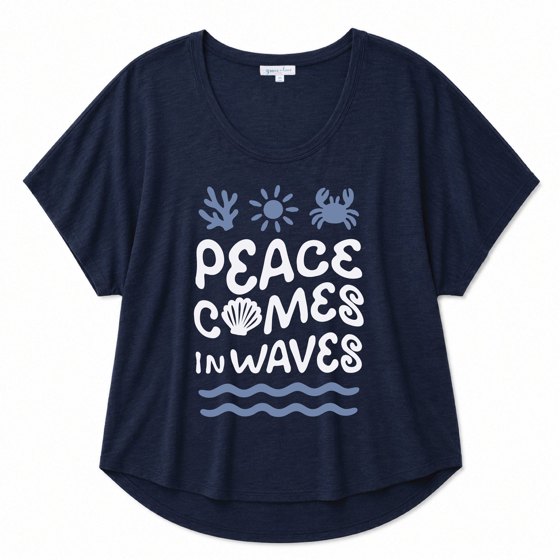 Navy graphic tee featuring a "Peace Comes in Waves" design on a beige background