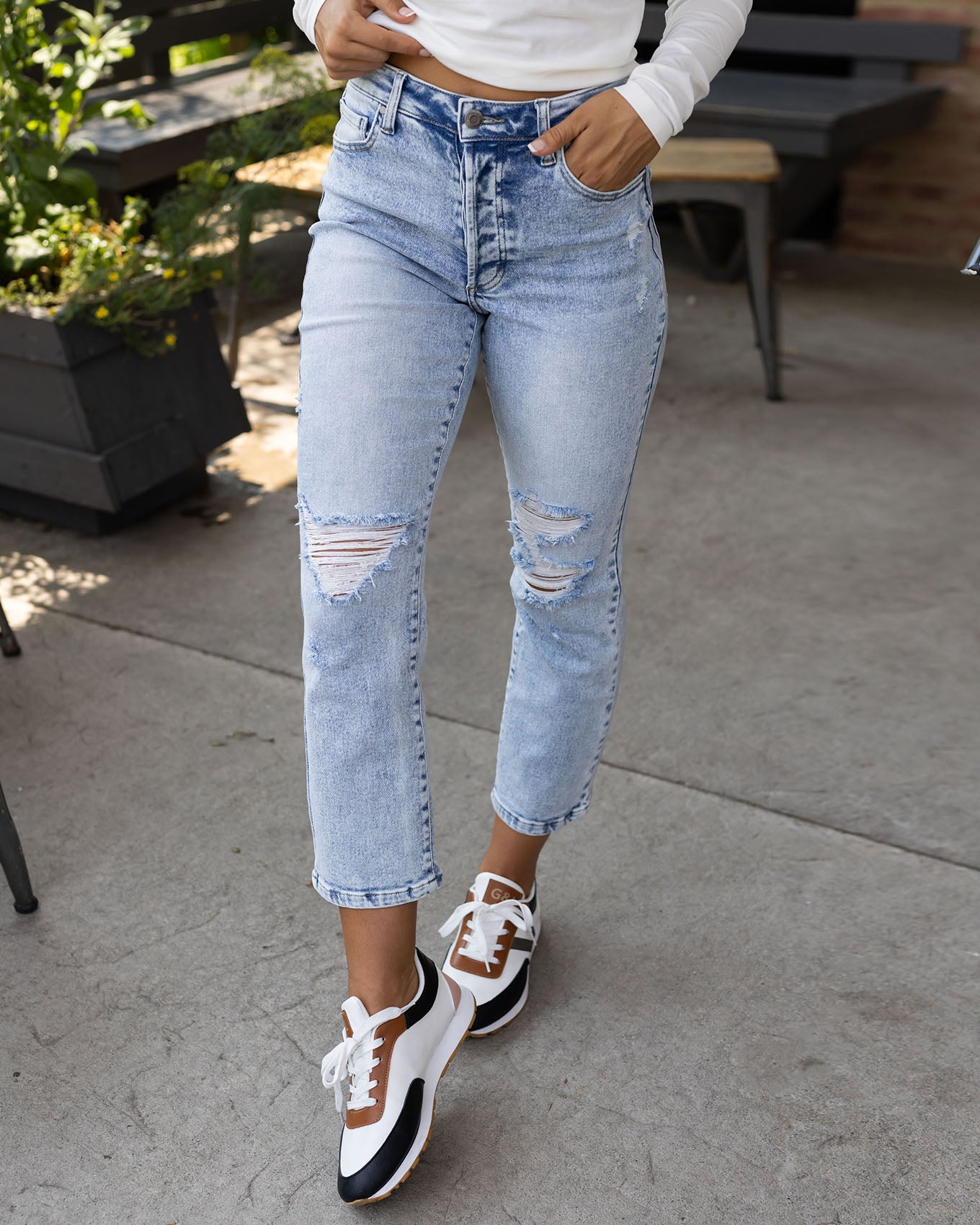 close up view of premium high waisted mom jeans in distressed light mid-wash